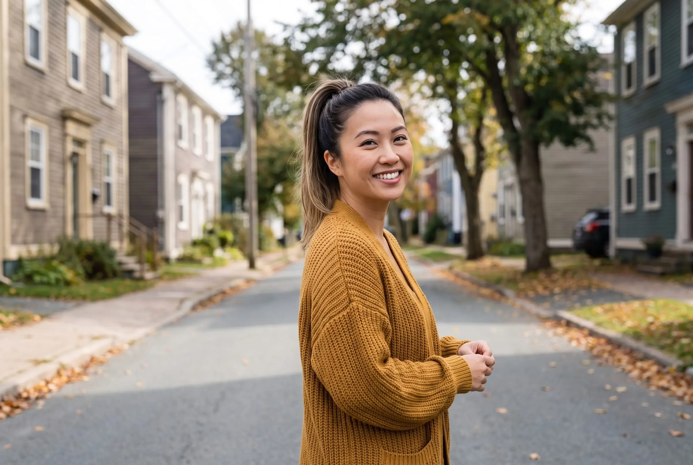 Jess Tran on a street of colourful houses in Halifax