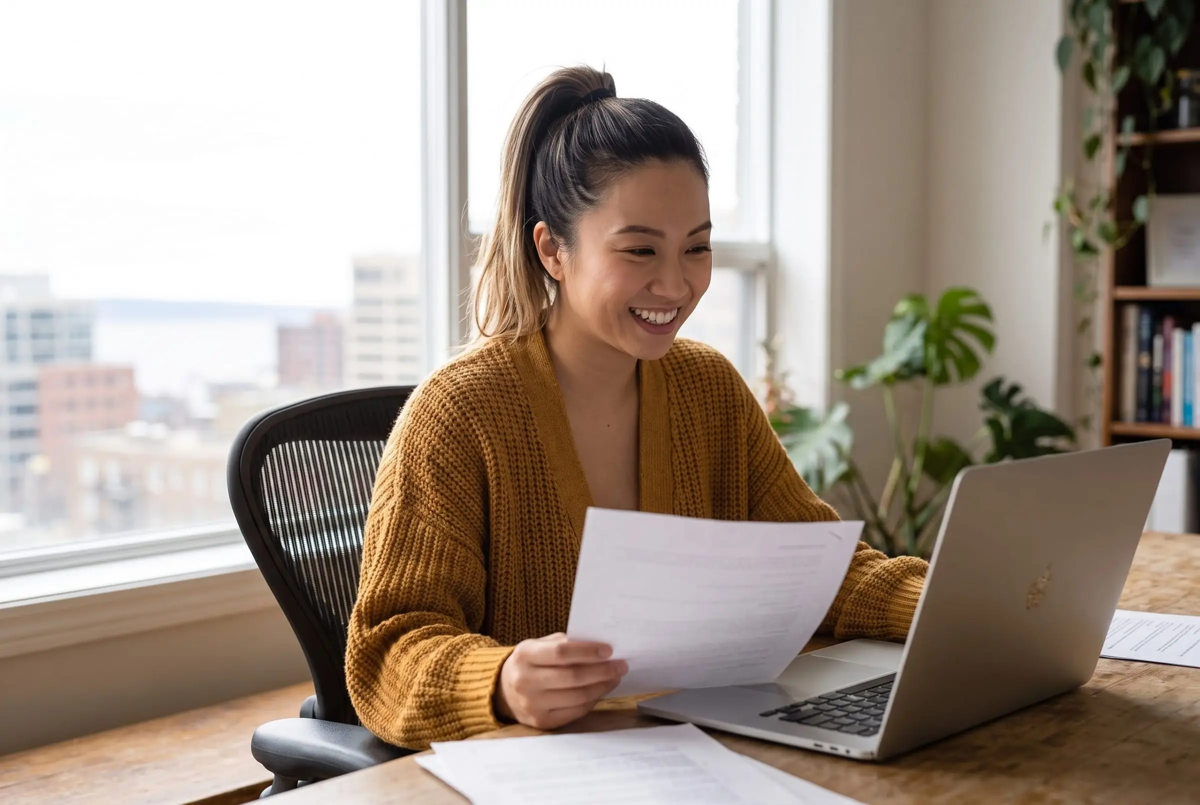 Jess Tran reading a document at her desk