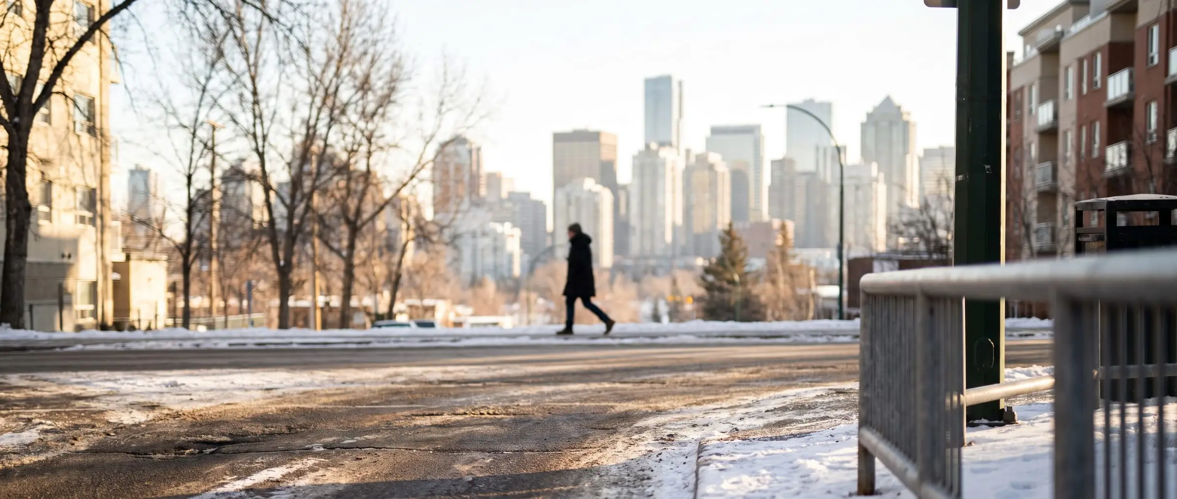 A Beltline street in Calgary with the downtown skyline behind