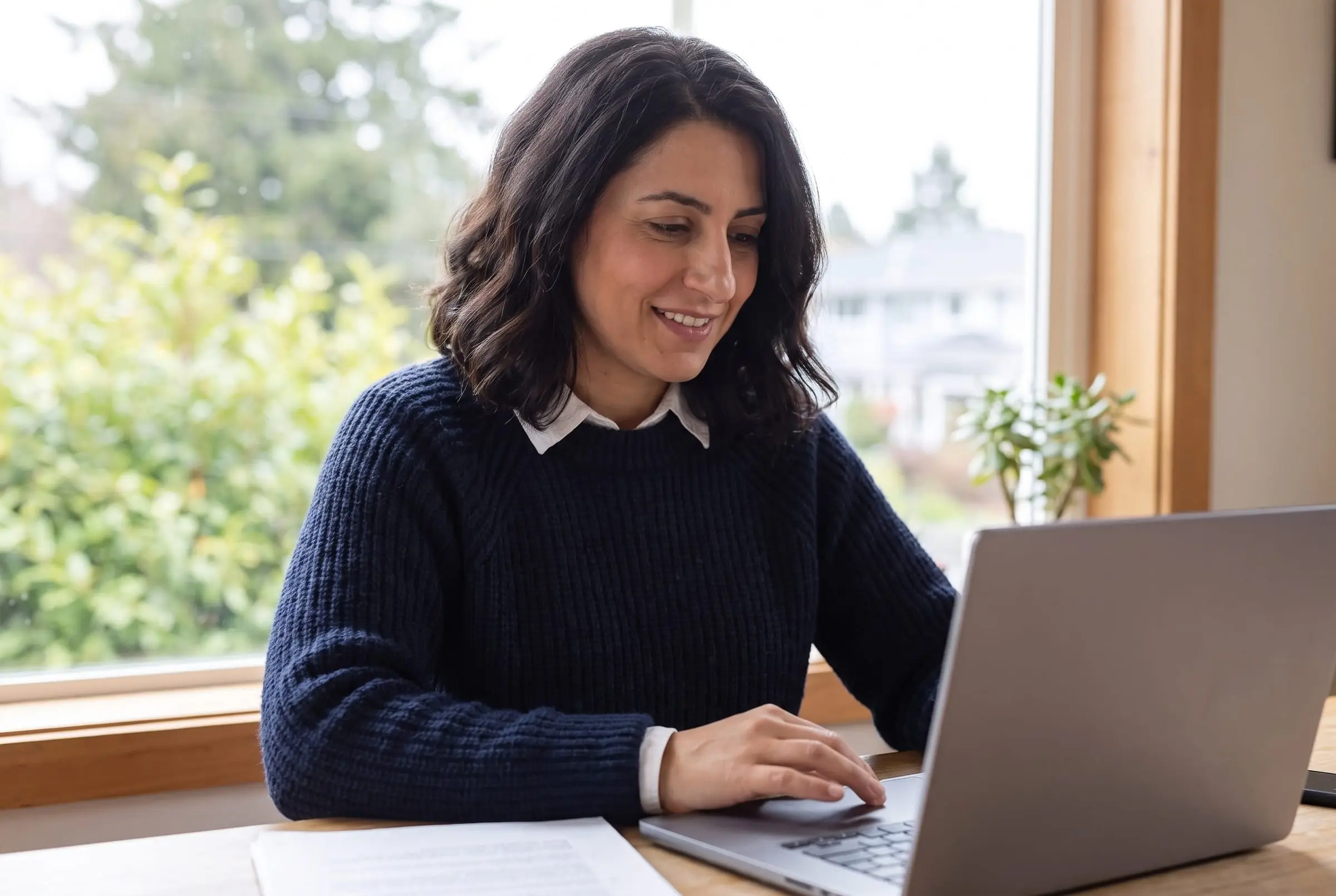 Nadia Haddad reviewing a client file at her desk