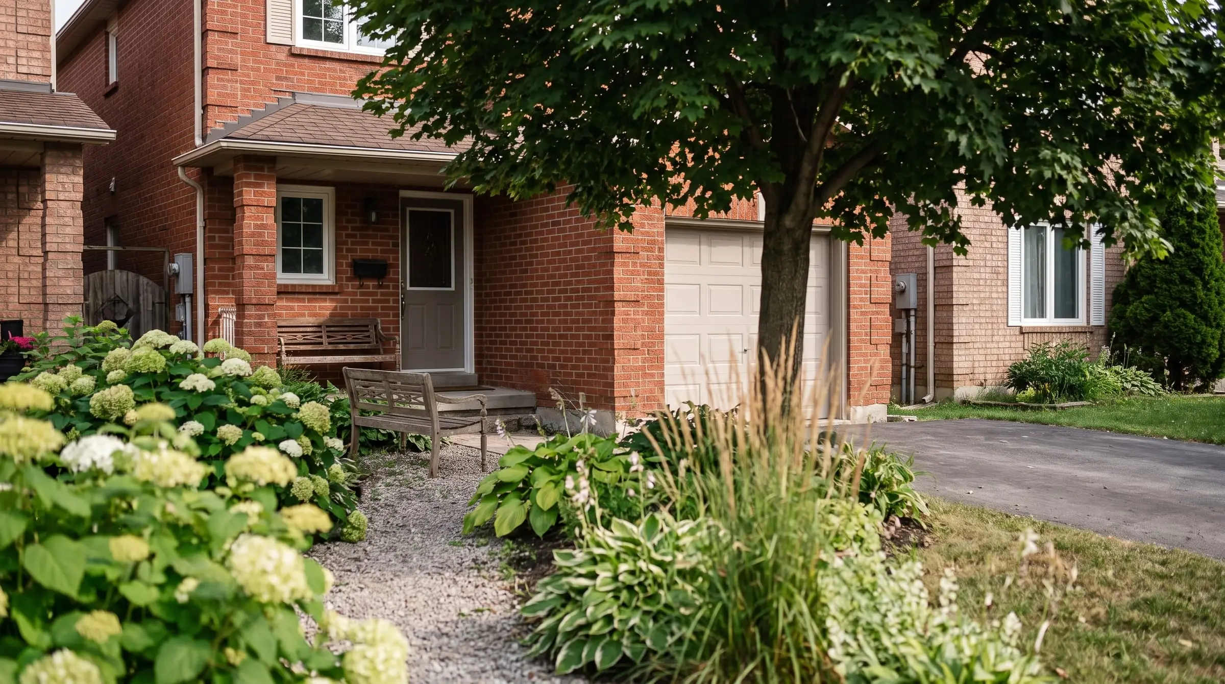 A semi-detached brick home with a front garden